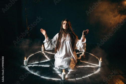 Witch in pentagram circle, evocation of spirits photo