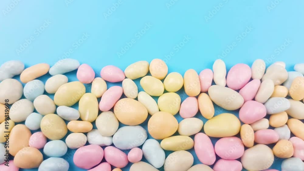 Sweet pastel color candy on blue surface. Sweet pastel color candy on blue surface.