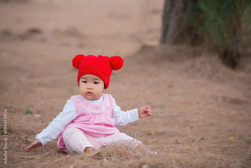 Portrait of cute asian little girl in the forest,Winter style concept Portrait of cute asian little girl in the forest,Winter style concept
