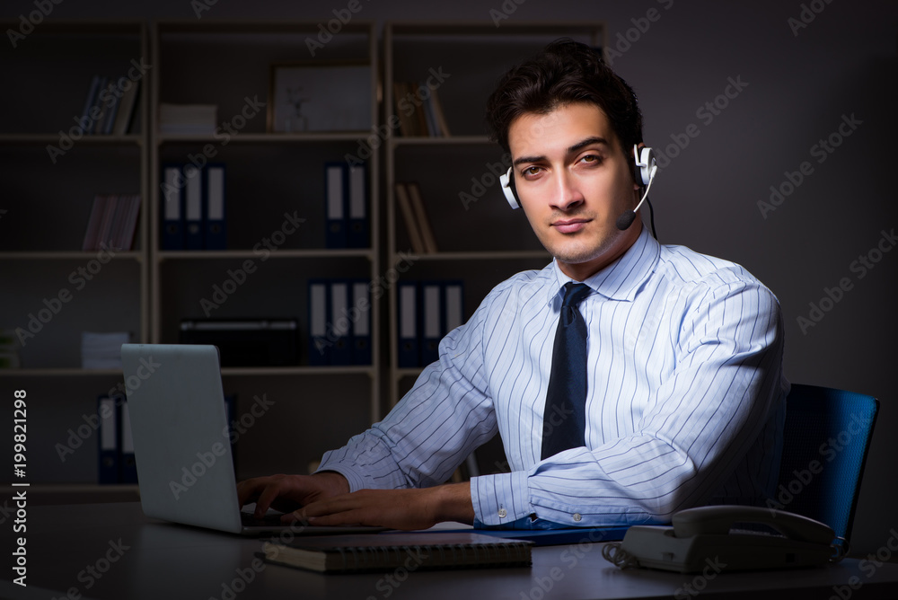 Obraz premium Call center operator talking to customer during night shift 