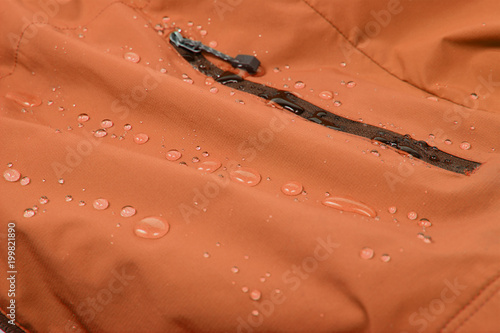 Water repellent coating durable repellency fabric outdoor shell jacket with water drops. Waterproof membrane with droplets. photo