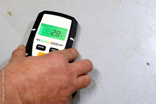 Measuring moisture in concrete floor. Space for text.