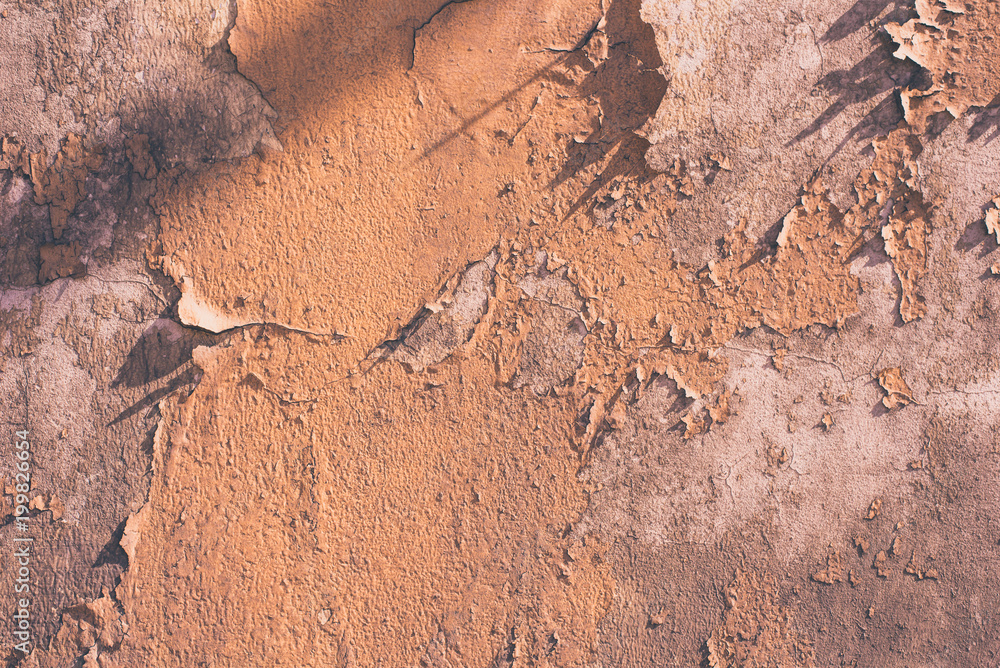Wall with remains of beige paint - light grunge background Wall with remains of beige paint - light grunge background