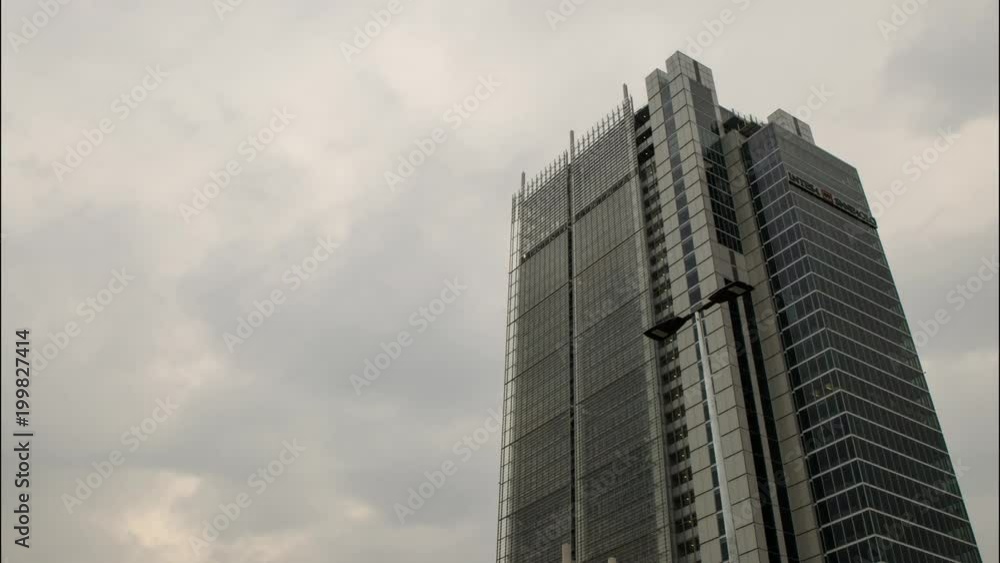 Turin, Italy, Piedmont. April 8 2018. The skyscraper, headquarters, of the Intesa - SanPaolo bank. Time lapse in which the gray and rain clouds are seen to flow. The signal lights flash. Turin, Italy, Piedmont. April 8 2018. The skyscraper, headquarters, of the Intesa - SanPaolo bank. Time lapse in which the gray and rain clouds are seen to flow. The signal lights flash.