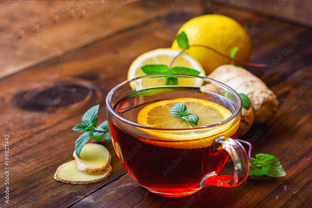Ginger tea with lemon on dark wooden background Ginger tea with lemon on dark wooden background