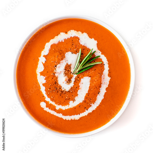 Tomato soup in a white  bowl  isolated on a white background. Gazpacho soup with herbs. Top view. Copy space.