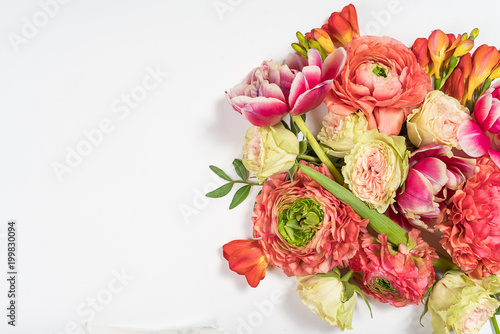 Floral pattern made of pink and beige roses, green leaves, branches on white background. Flat lay, top view. Valentine's background. Floral pattern. Pattern of flowers. Flowers pattern texture