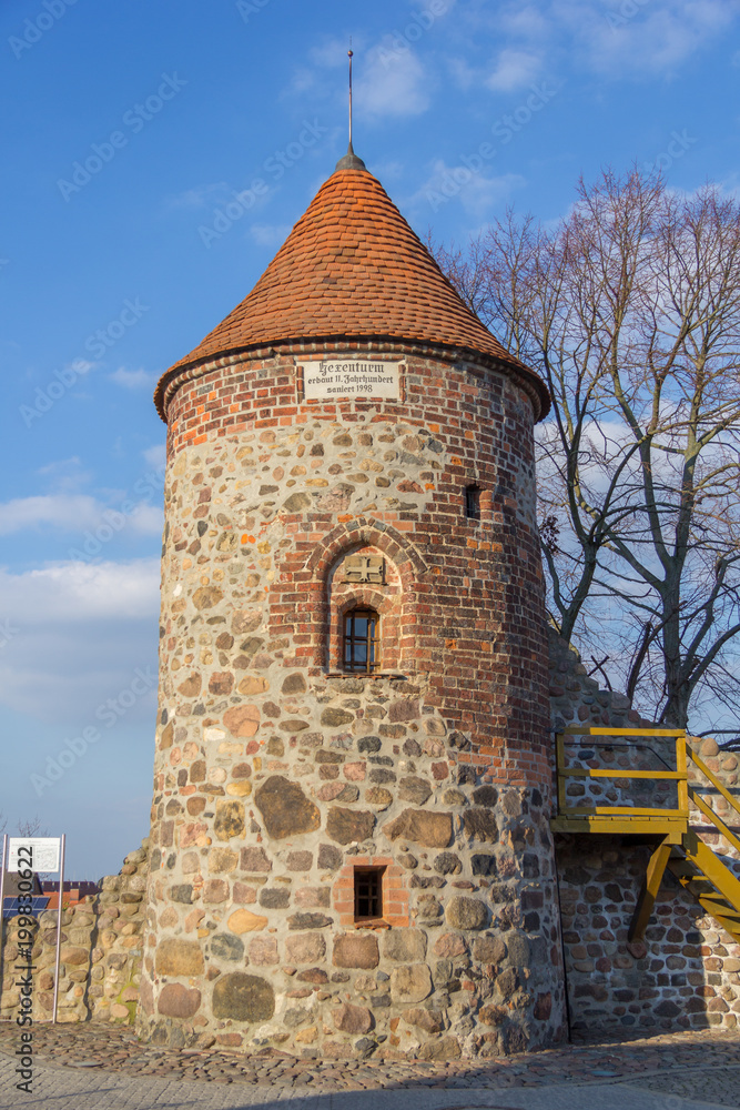 a stone witch tower in a european landscape