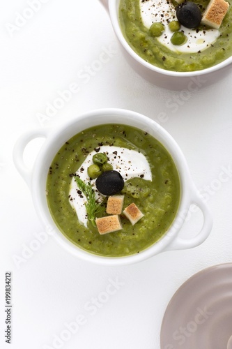 Delicious pea cream soup on the white background
