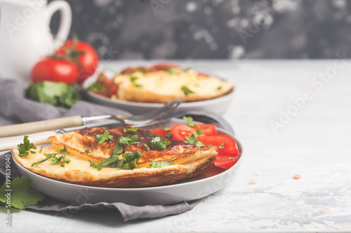 Delicious bright egg omelet with cheese and vegetables. Breakfast food concept, copy space.