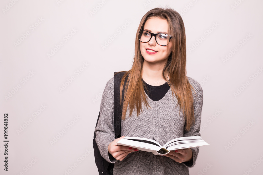Young student woman posing with open book over white background Young student woman posing with open book over white background