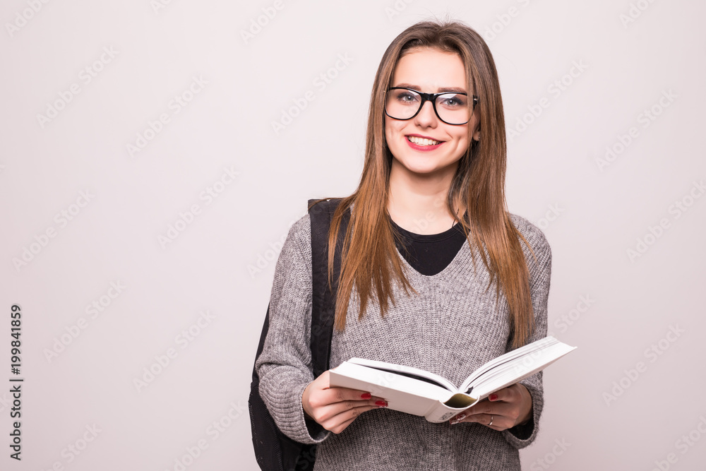 Portrait of a cheerful smiling african student girl wearing backpack and holding books isolated over white Portrait of a cheerful smiling african student girl wearing backpack and holding books isolated over white