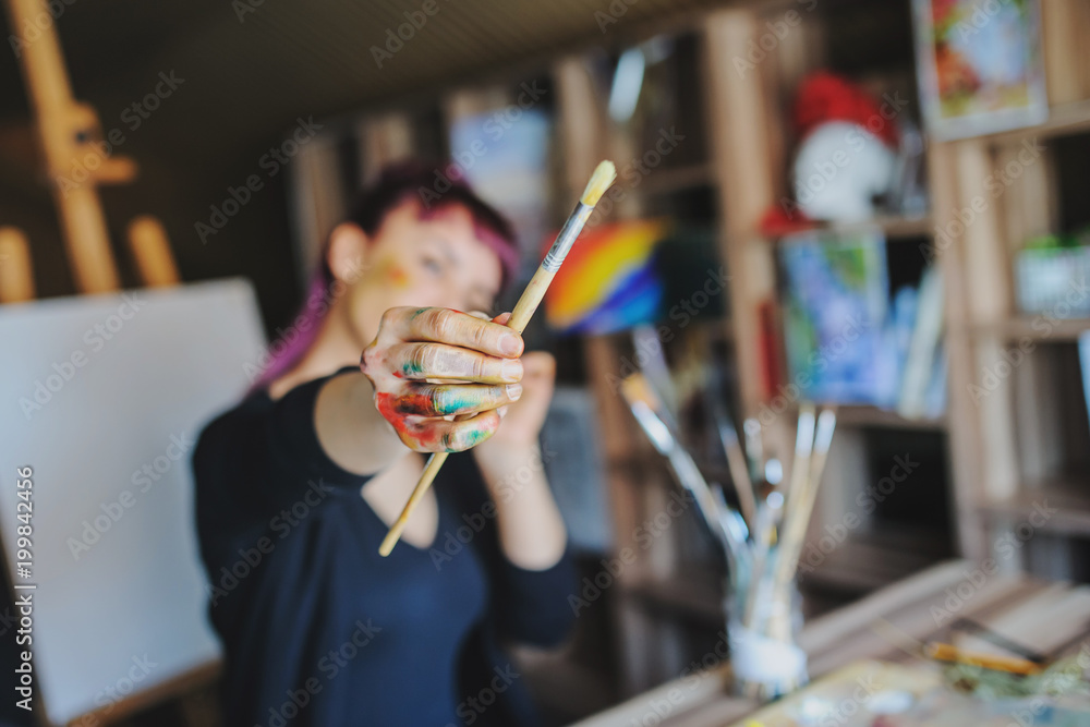 Fototapeta premium Selective focus on female artist dirty hands