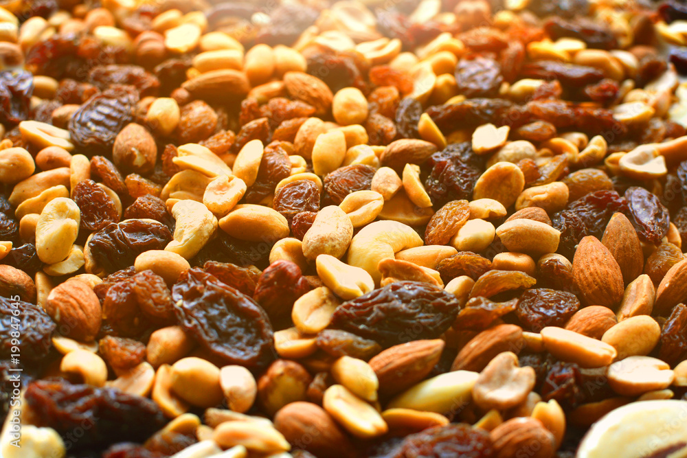 Background with a cashew, hazelnuts, raisins and peanuts. Assorted nuts and raisins with a place for your design. Background with a cashew, hazelnuts, raisins and peanuts. Assorted nuts and raisins with a place for your design.