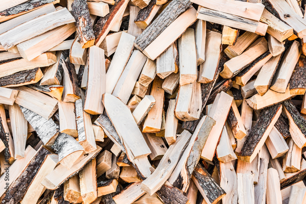 chaotically arranged in a pile of fresh chopped firewood, abstract background chaotically arranged in a pile of fresh chopped firewood, abstract background