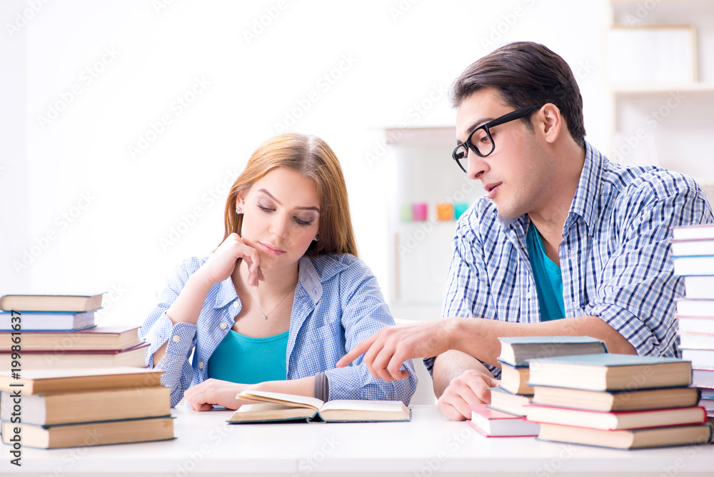 Pair of students studying for university exams Pair of students studying for university exams