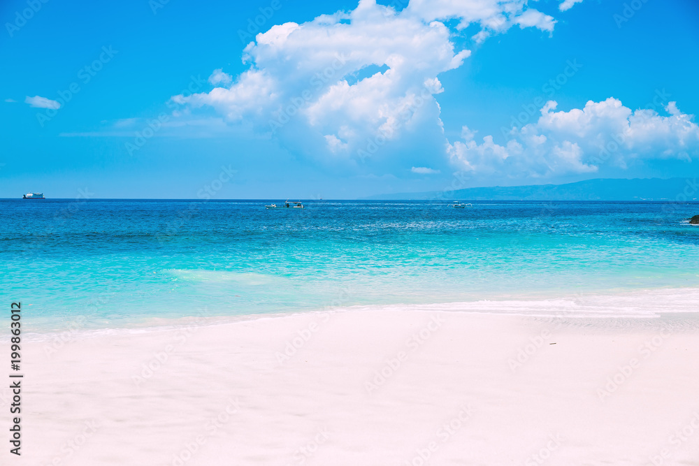 Tropical white sand beach and blue ocean in Bali