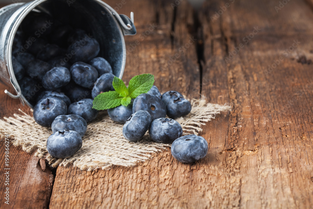 Blueberry on wooden table background. Ripe and juicy fresh picked blueberries closeup. Berries closeup with copy space Blueberry on wooden table background. Ripe and juicy fresh picked blueberries closeup. Berries closeup with copy space