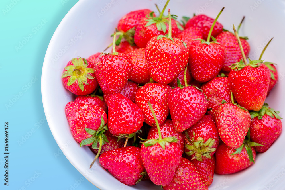 Close up of fresh strawberry in the white bowl on bright background. Close up of fresh strawberry in the white bowl on bright background.
