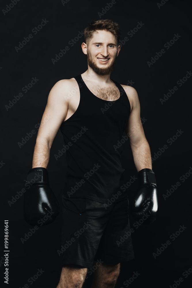 Portrait of a sporty man staying with boxing gloves and smilling at camera. Portrait of a sporty man staying with boxing gloves and smilling at camera.