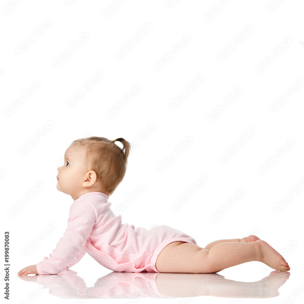8 month infant child baby girl toddler lying in pink shirt looking at corner isolated on a white 8 month infant child baby girl toddler lying in pink shirt looking at corner isolated on a white