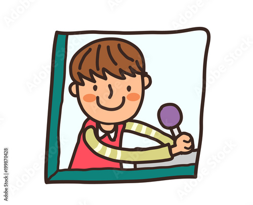 Side view of boy holding lollypop