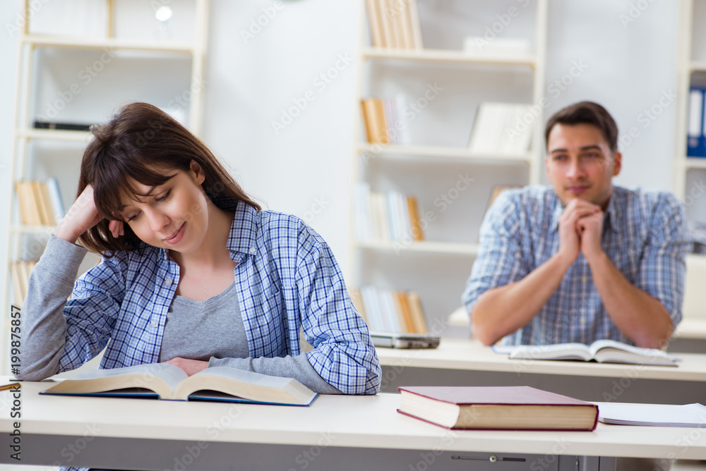 Students sitting and studying in classroom college Students sitting and studying in classroom college