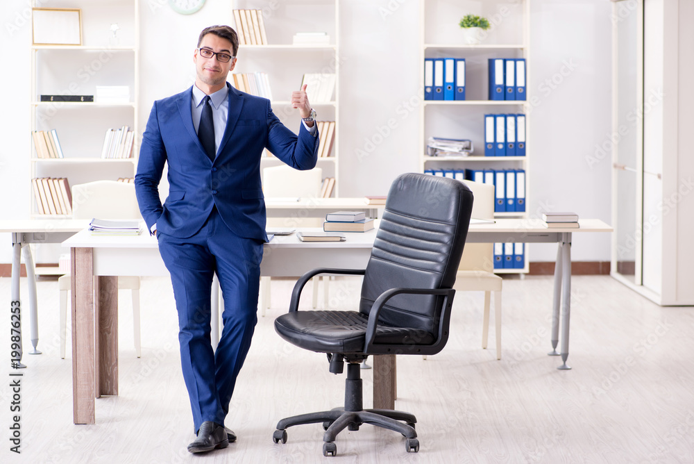 Young handsome businessman employee working in office at desk Young handsome businessman employee working in office at desk