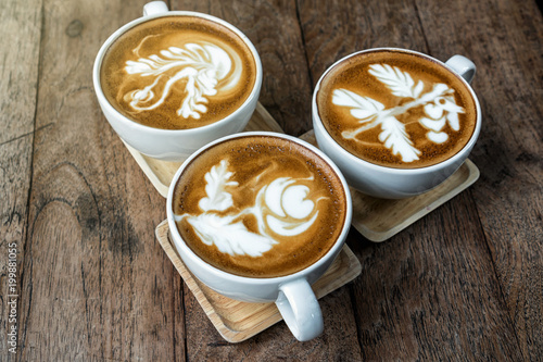 Top view of coffee cup set which consist of latte art and capuchino ooer the wooden table  drink and coffee shop concept