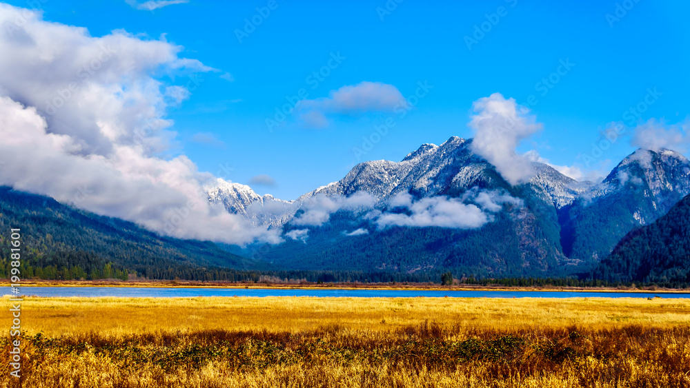 Snow covered peaks of Coquitlam Mountain and other peaks of the Coast Mountains surrounding the Pitt River and Pitt Lake in the Fraser Valley of British Columbia, Canada on a clear winter day