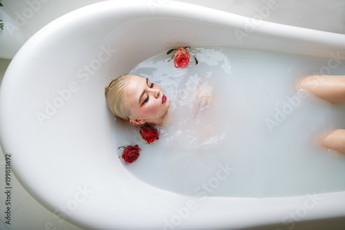 portrait of sexy girl in a bath with milk