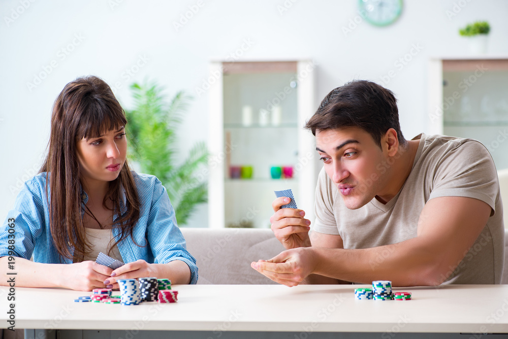 Young family playing cards at home Young family playing cards at home