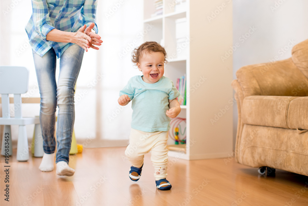 © Oksana Kuzmina - Baby toddler have a fun running in living room with his mother © Oksana Kuzmina - Baby toddler have a fun running in living room with his mother