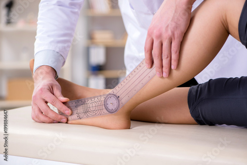 Doctor checking patients joint flexibility photo