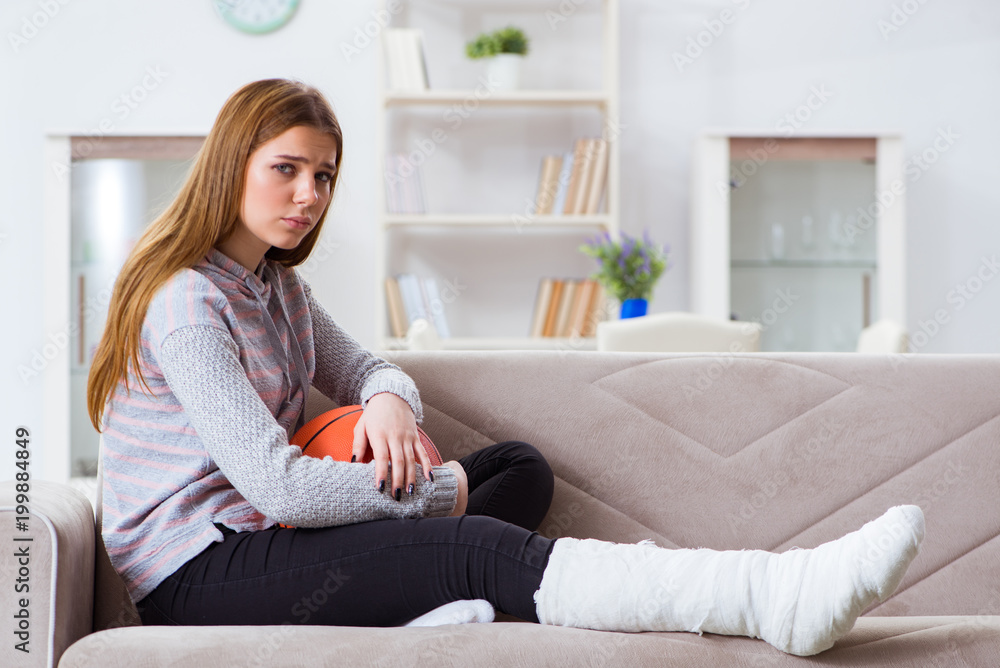 Young woman with broken leg at home