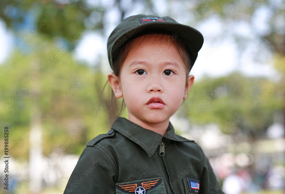 Close-up of Asian child girl in pilot soldier suit costume. Close-up of Asian child girl in pilot soldier suit costume.