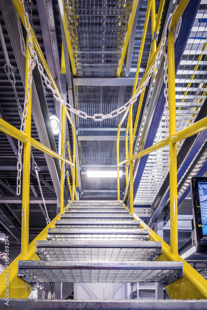 Metal staircase, with yellow railings and metal steps. Metal staircase, with yellow railings and metal steps.