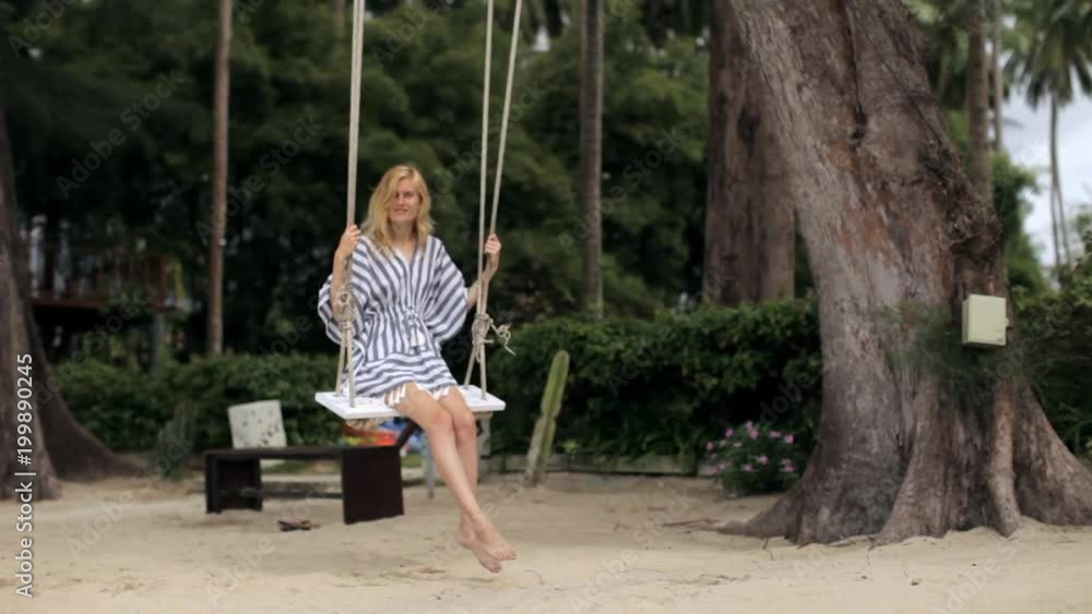 beautiful girl on a swing in the tropics beautiful girl on a swing in the tropics