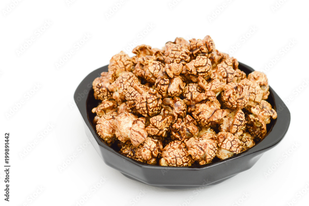 Photo of chocolate popcorn in black bowl on white background. Photo of chocolate popcorn in black bowl on white background.