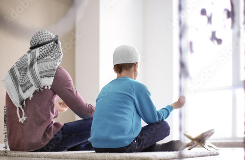 Muslim father and son prayi...