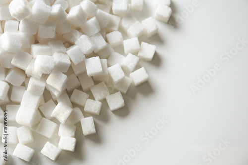 Refined sugar cubes on light background