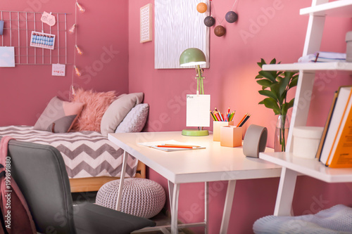 Comfortable desk and bed in...
