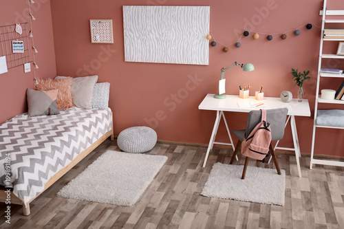 Comfortable bed and desk in...