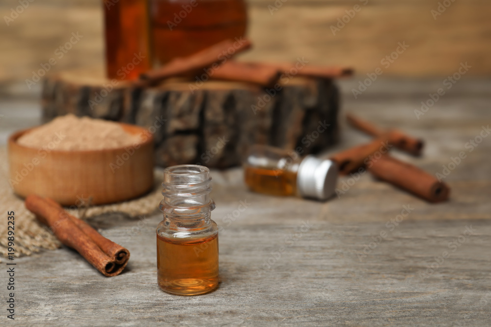 Closeup of bottle with cinnamon oil on wooden table