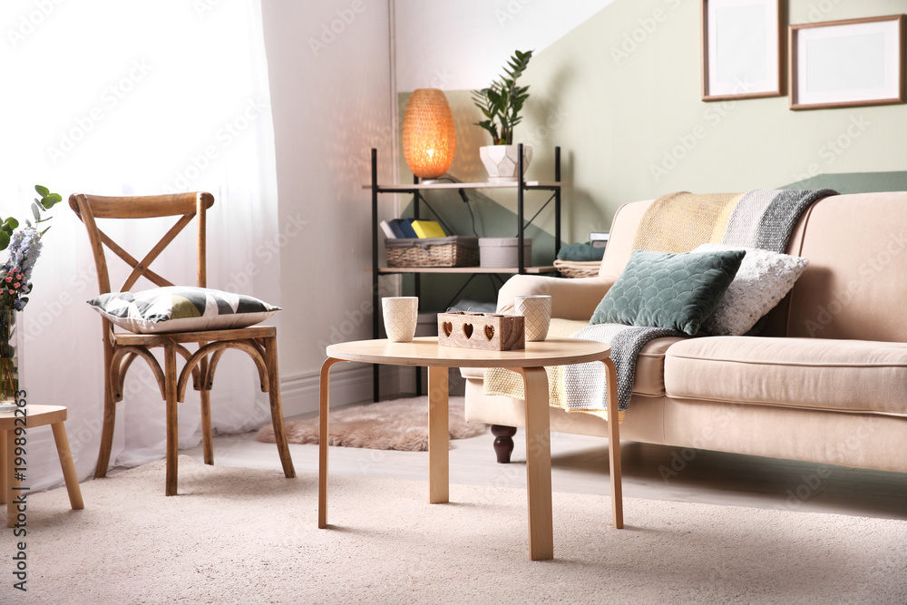 Stylish living room interior with comfortable sofa and small table Stylish living room interior with comfortable sofa and small table