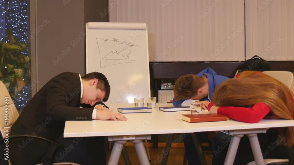 Businessmen asleep at a meeting in the office Businessmen asleep at a meeting in the office
