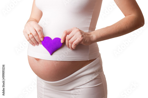 Wallpaper Mural pregnant woman put a violet toy heart to his stomach isolated on white Torontodigital.ca