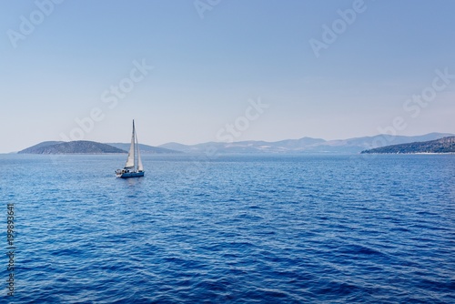 Small sailboat on the calm waters
