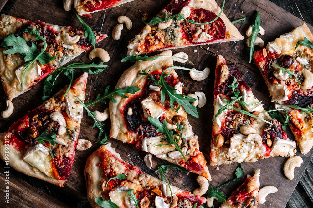 Vegetarian pizza with beetroot on wood background.