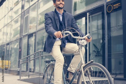 Smiley businessman driving bike on street.